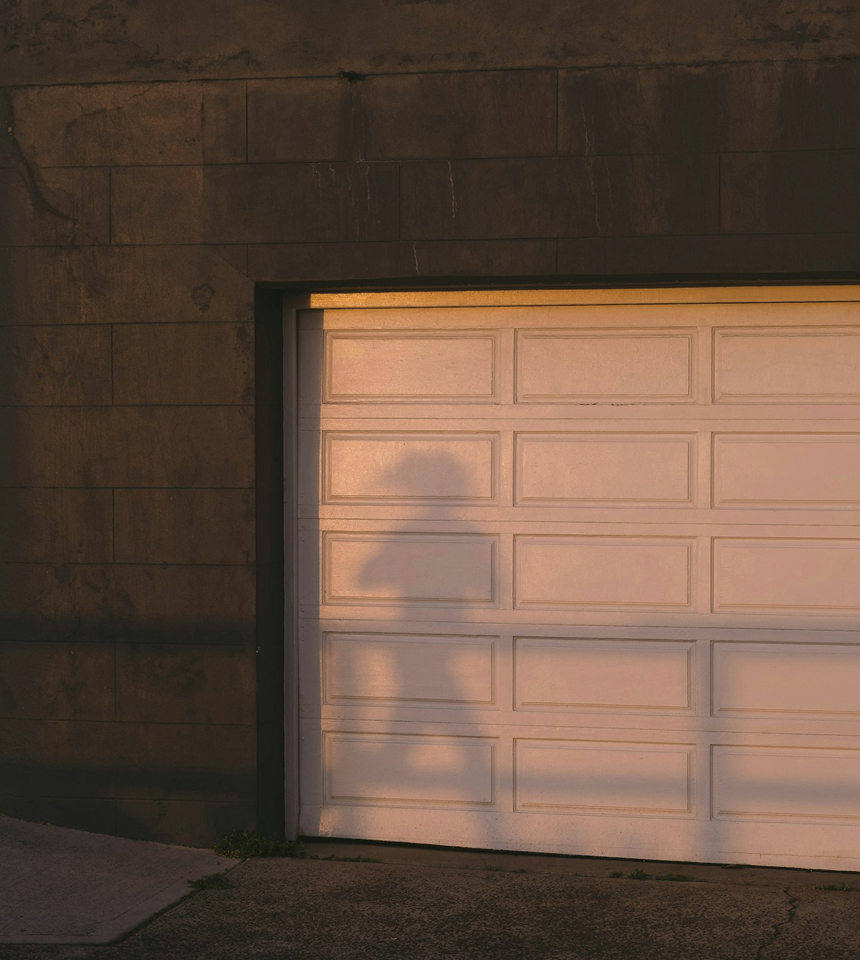 Man Using Measuring Tape in Factory Setting Man Using Measuring Tape in Factory Setting