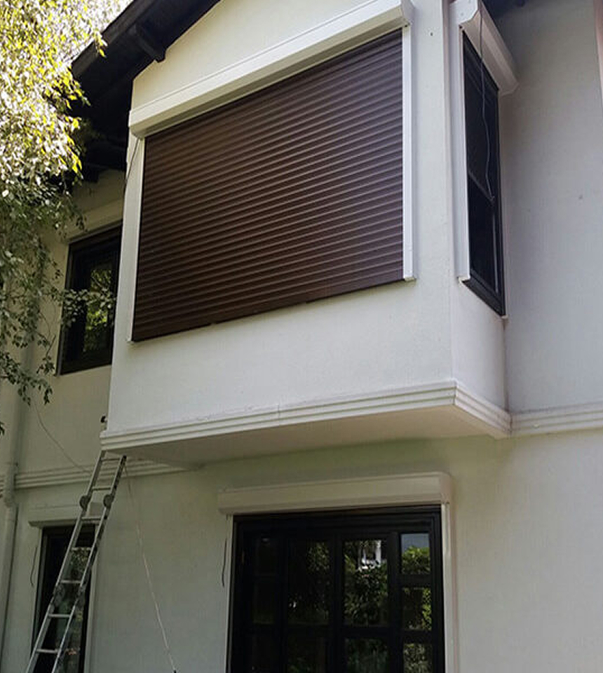 Man Using Measuring Tape in Factory Setting Man Using Measuring Tape in Factory Setting