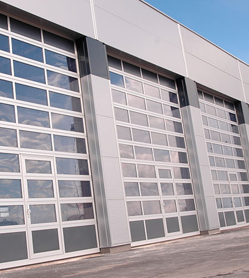 Man Using Measuring Tape in Factory Setting Man Using Measuring Tape in Factory Setting