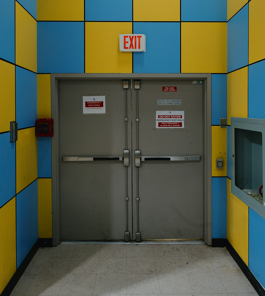 Man Using Measuring Tape in Factory Setting Man Using Measuring Tape in Factory Setting